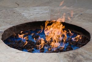 Ornamental fire pit with lava rocks and crystals.