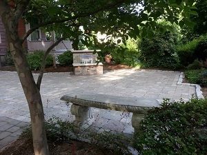 Photo of a finished Dolan patio, complete with fountain and bench.