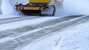 Snowplow clearing the snow from the street or property