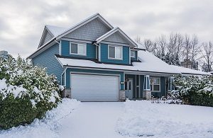 Home with snow around the yard and on the house