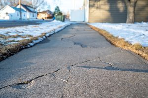 Frost heave crack in residential concrete sidewalk