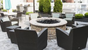 Patio with outdoor seating, fire pit, and grills to host and entertain in your backyard.