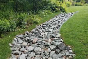 Graded Lawn with rock drainage.